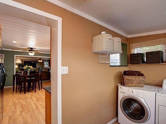 The laundry room is conveniently located next to the kitchen.
