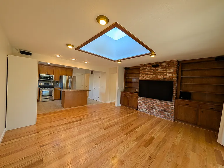 Family room and kitchen, facing hallway and garage door.