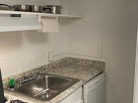 Kitchen with full size fridge, dishwasher, microwave