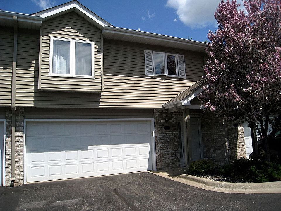 Front of house with blossoming tree.