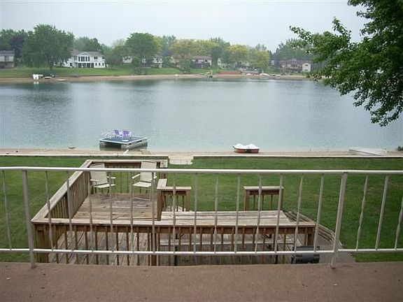 view of lake and deck from upper deck on home