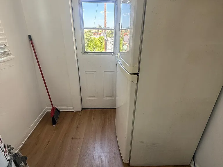kitchen hallway with door to use outside steps to go