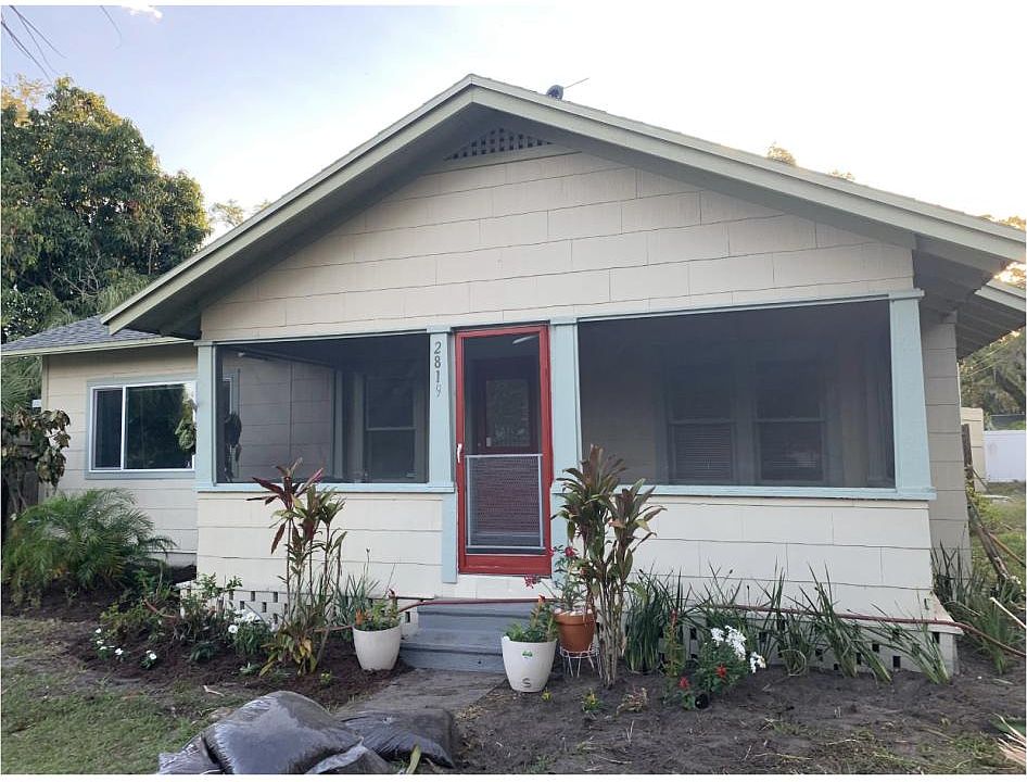 Front of house showing large screened porch
