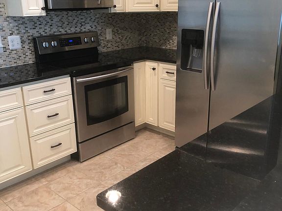 Granite countertops and stainless steel appliances in the kitchen