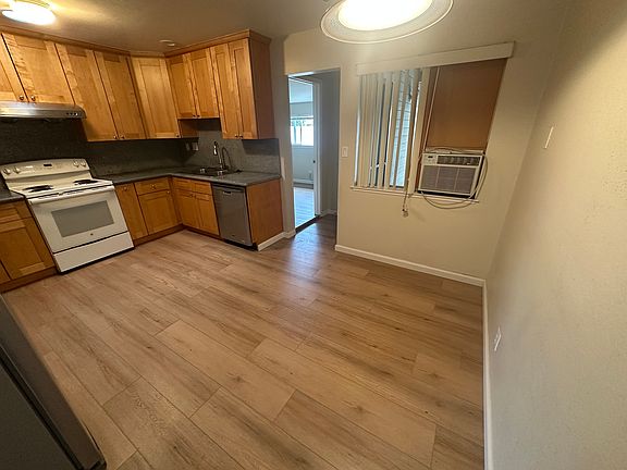 Kitchen, entry to third bedroom and back entrance