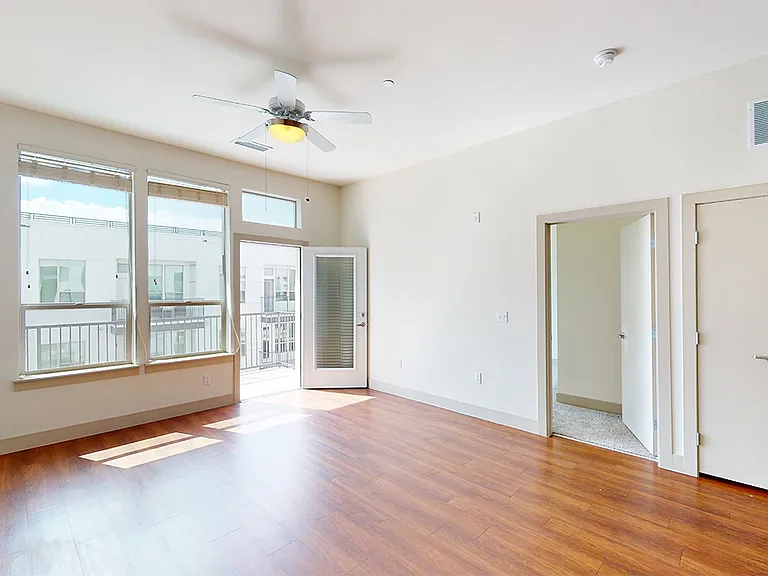 Apartment dining and living room with wood-style flooring.