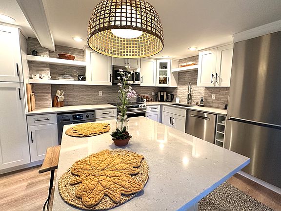 Newly renovated kitchen with everything you need! D/W, fridge with ice maker, microwave, toaster oven, electric kettle, coffee machine, and all your pot and pans, glasses and dishes.