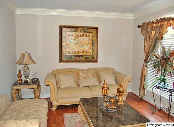 SPACIOUS LIVING ROOM WITH HARDWOOD FLOORS AND A LOT OF NATURAL LIGHT