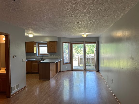 Living and dining space, as well as the half bathroom all on the main level. Sliding door going outside to the deck and backyard