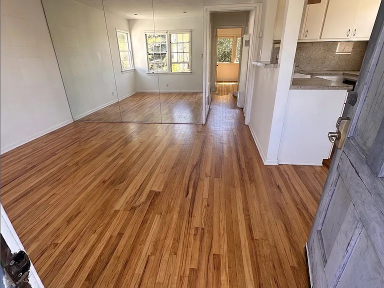 Open living area and floor to ceiling mirrors