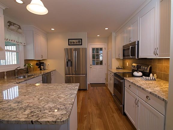 Totally remodeled kitchen with granite countertops, stainless steel appliances & wood floors.
