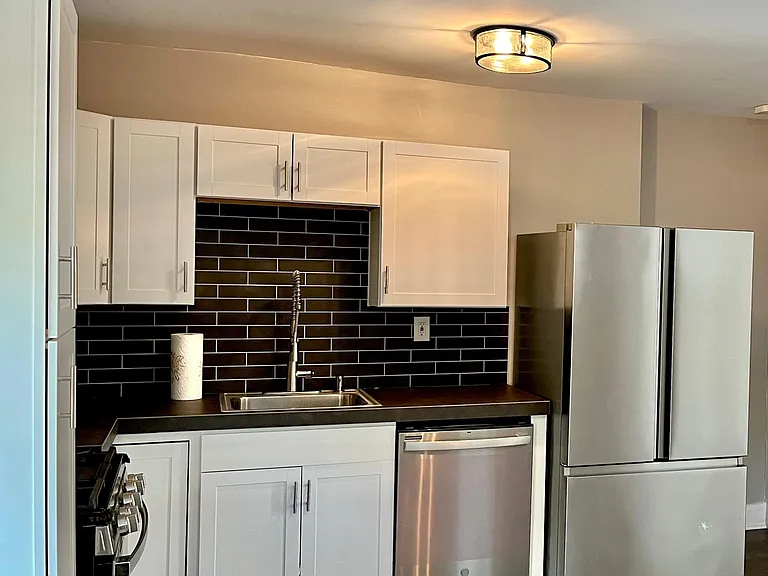 Clean simple kitchen. Large size fridge.