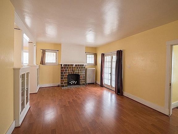 Large and Beautiful Living room with decorative Fire Place, Light and bright and hard wood floors.