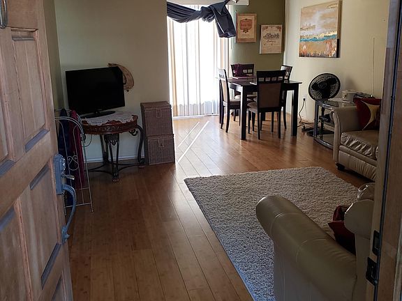 Entryway view of living room into dining area.