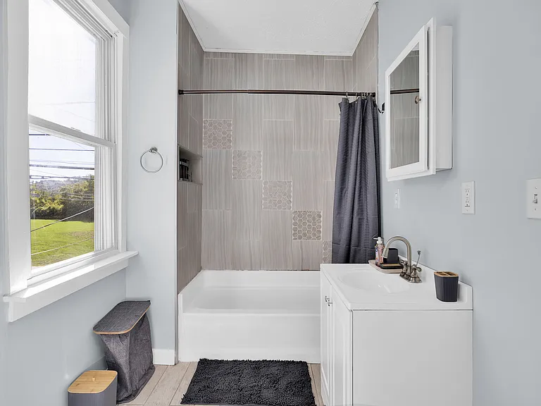 Bright, clean bathroom with essentials provided.