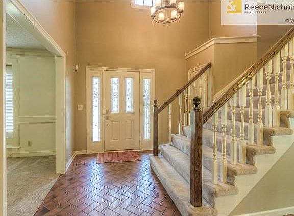 Two-story entry with new light fixture and upgraded Pella front