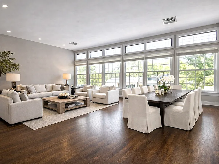 Open layout is framed by a stunning walled window that spans the entire living / dining areas