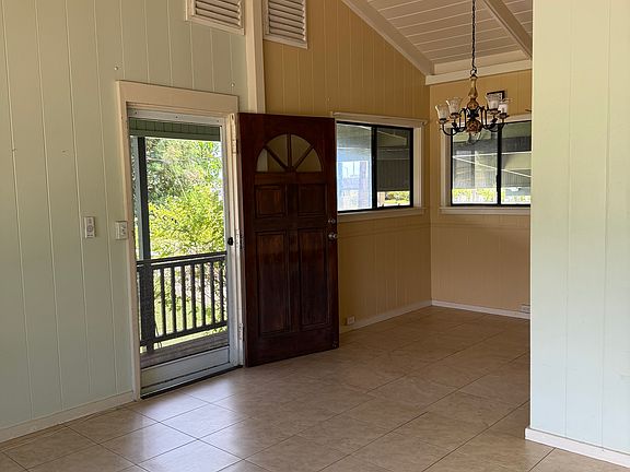 Tiled kitchen, dining, and living room space.