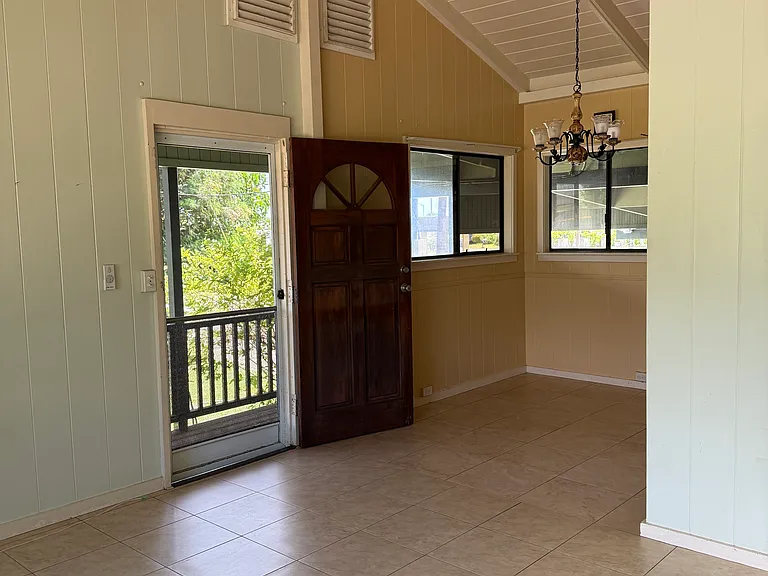 Tiled kitchen, dining, and living room space.