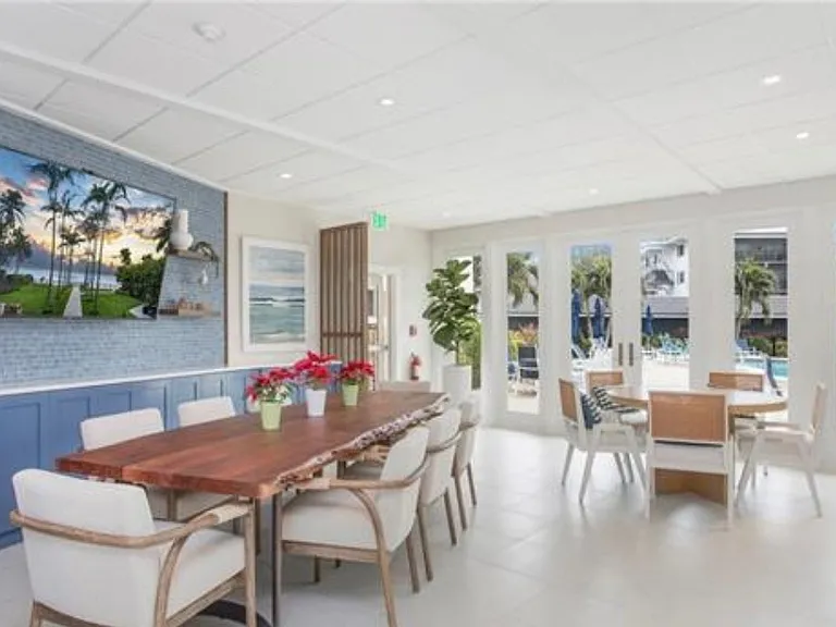 Social room - recently renovated with high end furnishings. Outside those glass doors is the pool.