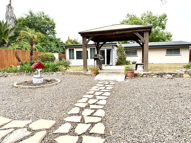 Beautiful gazebo with an outdoor barbecue area, surrounded by lush garden landscaping_perfect for cozy evenings and enjoying the cool breeze.