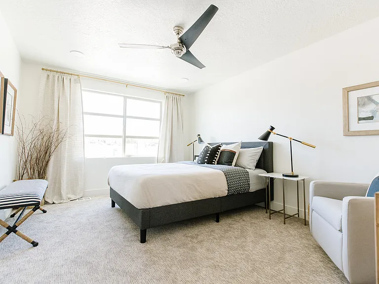 Master bedroom has big bright window and walk in closet with custom shelving