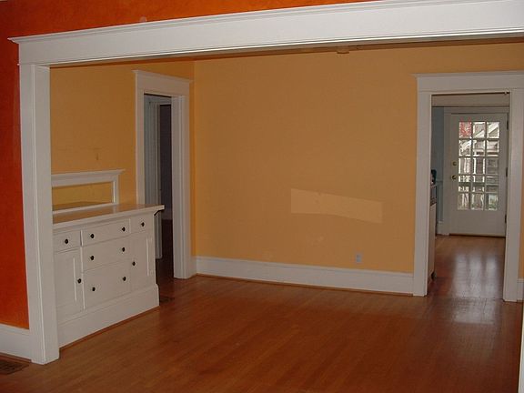 Dining room features large windows and built-in sideboard.