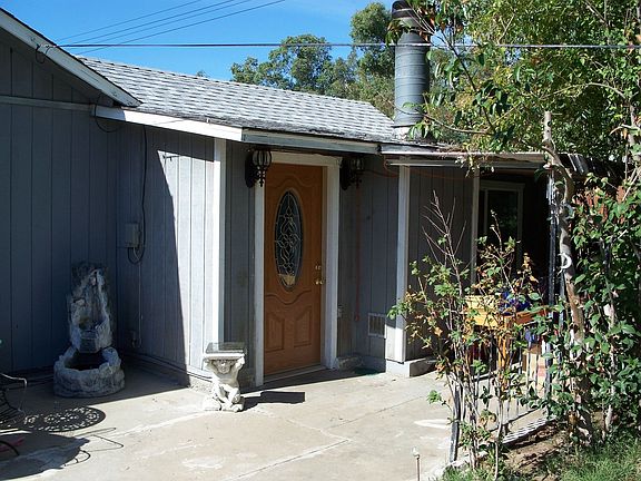 View of front door w/covered porch to the right