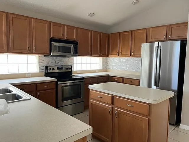 Kitchen with Stainless Steel appliances and backsplash