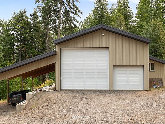 Massive shop- total size 54x36. Consists of 30x36 shop with concrete floors & wood stove. The insulated side storage room is plumbed for bathroom- (water & power are active.) The lean-to is 24x36 for extra covered parking!