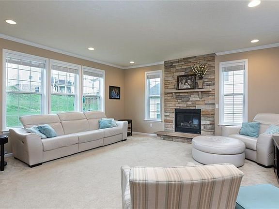 Family room again with huge windows to bring the outside in, gas Stone to ceiling fireplace, Upgraded Shaw carpet.