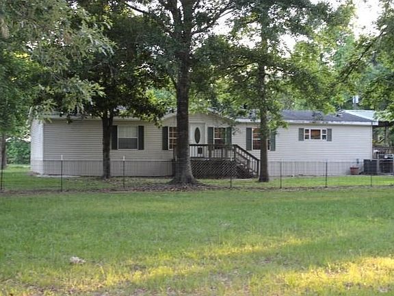 3 Bedrooms w/3 bathrooms with extra large living room. Covered patio overlooks 5 acres.