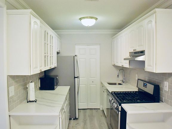Galley style kitchen/ door to utility closet where washer/dryer located