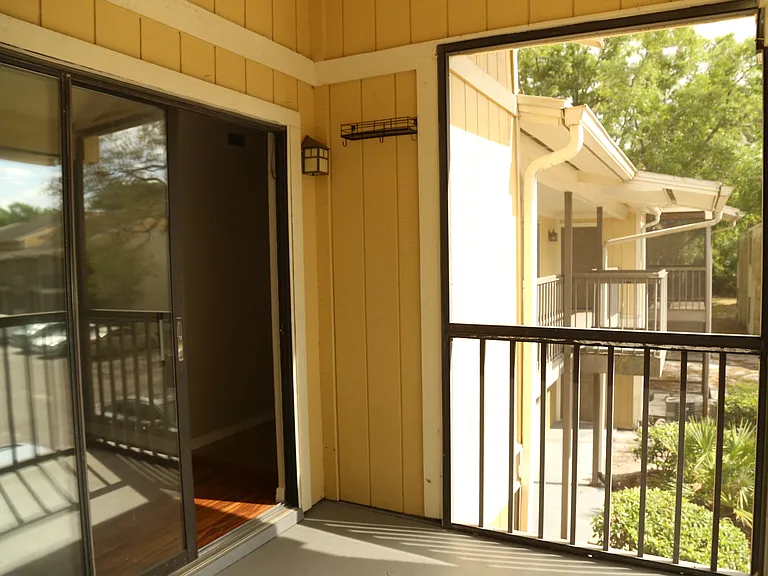 Screened in porch, sliding glass doors leading into living room