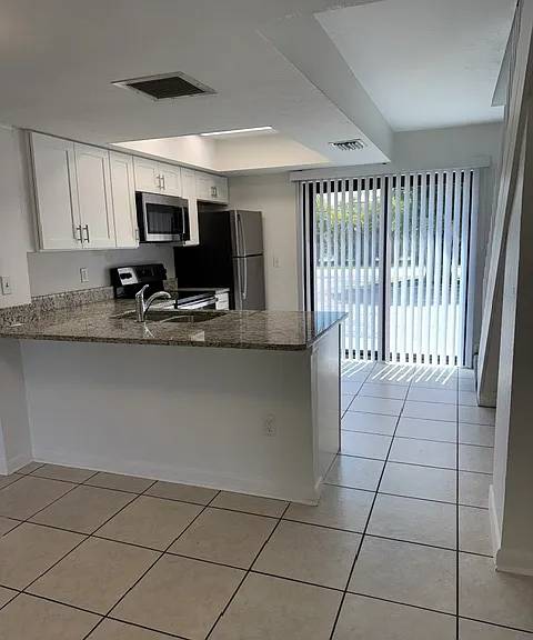 Kitchen w/Stainless Steel appliances
Cooktop Range, microwave, dishwasher, refrigerator.