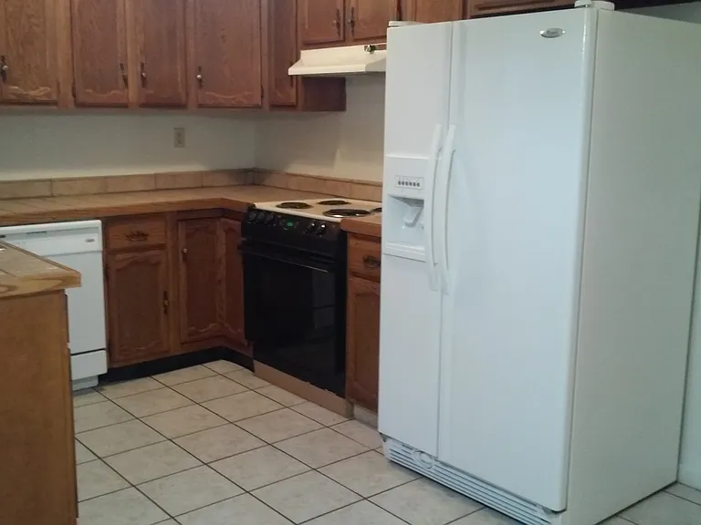 Kitchen with side y side refrigerator