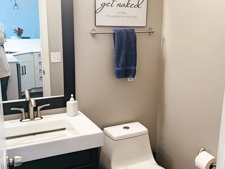 Main level half bath with extra tall vanity.