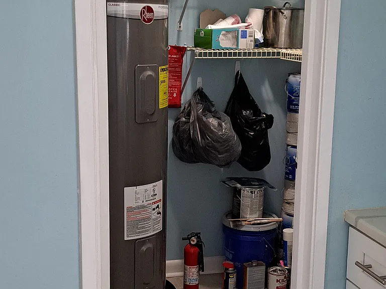 Pantry with with shelves galore and oversized water heater updated in 2017.