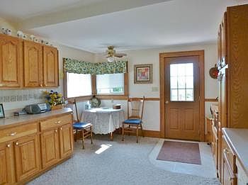 Another view of the kitchen with breakfast area and views of the deck and back acreage!