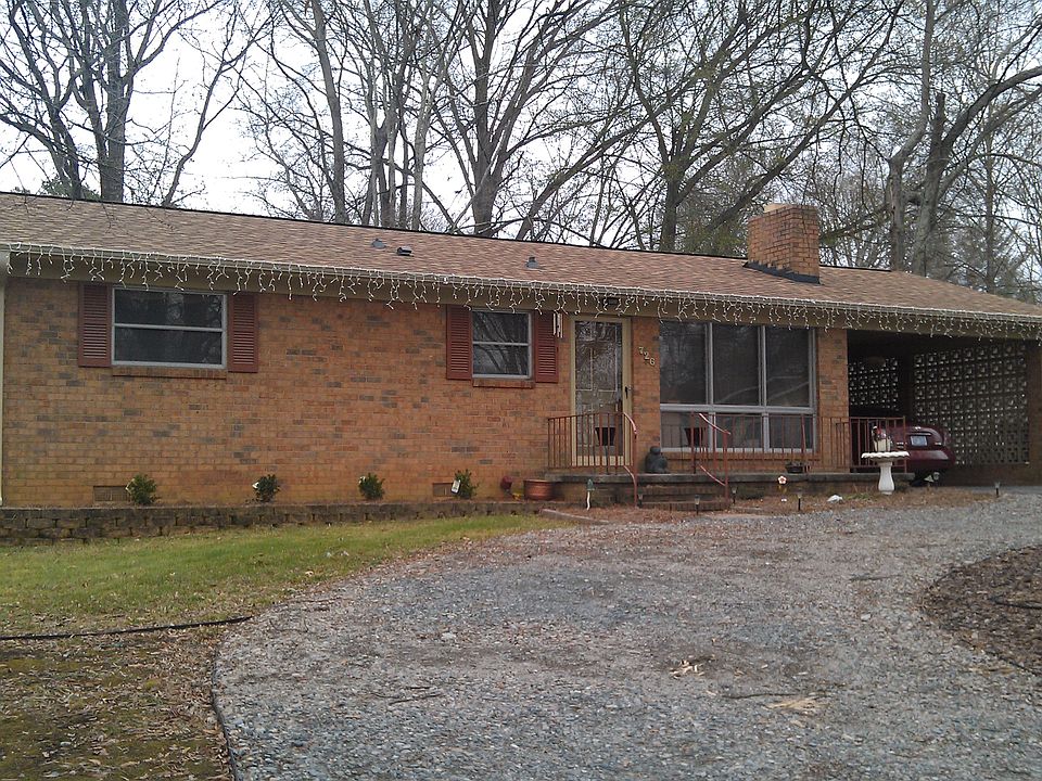 front of home with gravel circle drive