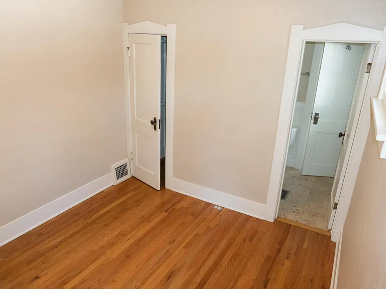 The front bedroom. the closet door is on the left and the entrance to the bathroom is on the right.