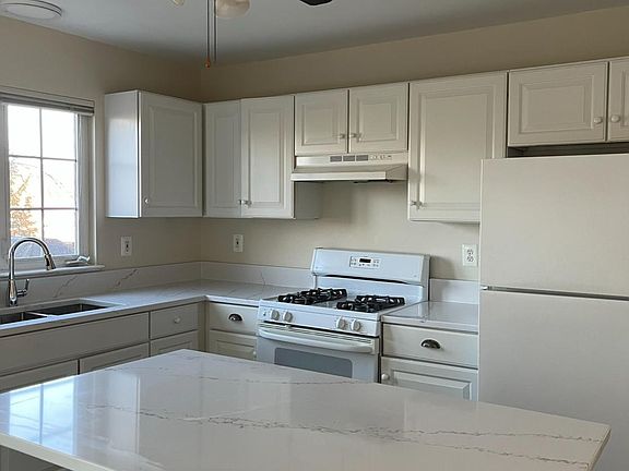 Kitchen, with granite countertops. Microwave included with gas stove and dishwasher.