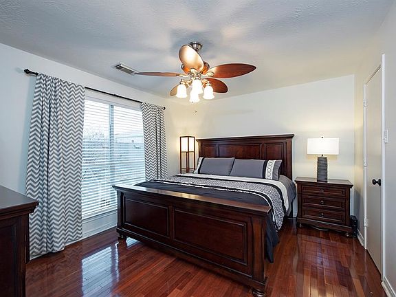 Primary with gleaming wood floor