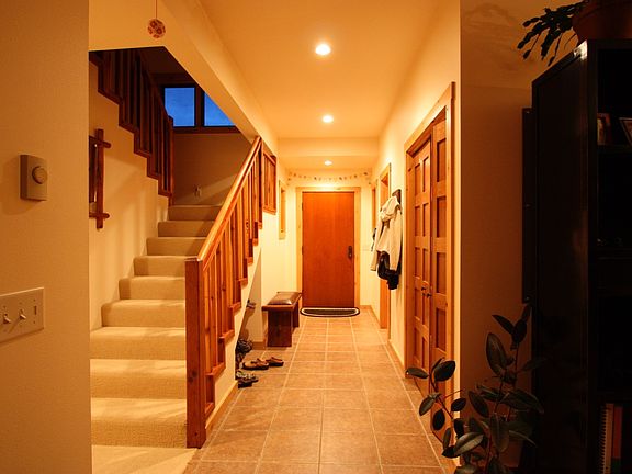 Entrance, coat closet and powder room on the right