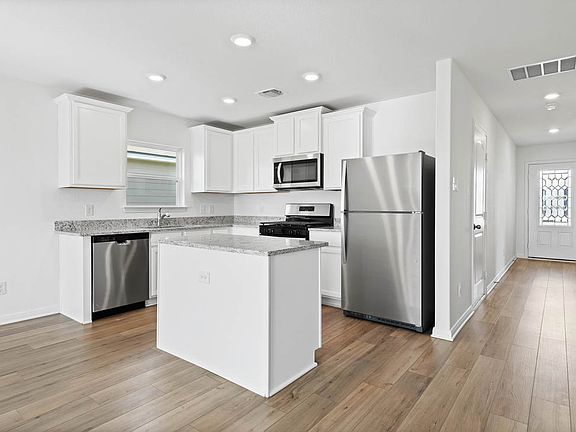The kitchen comes with white cabinets and granite countertops you will love!