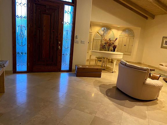 View of front door and living room from inside entranceway