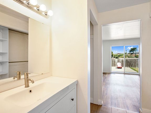 Looking out from the master bath, you see the walkthrough closet, the master bedroom, and wonderful views out the back windows