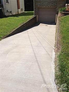 NEW CONCRETE DRIVEWAY and wall is in great condition!
