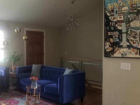 Living area, front door, stairs to basement