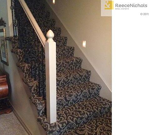 Staircase refinished with top of the line carpet and rod iron ra